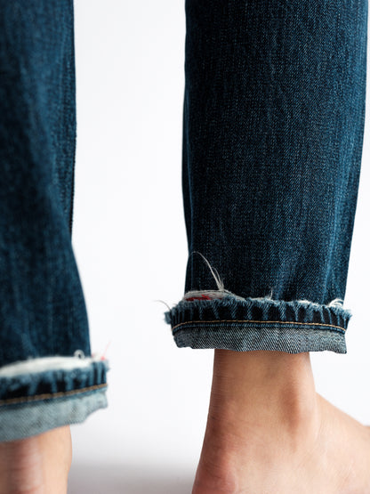 Close-up view of the B O R O デニム (BORO DENIM) 'Eagle Birds' Tokyo jeans, emphasizing the roll-up hem style. The shot reveals the premium Japanese Selvedge fabric, adding a touch of playful elegance to the design.